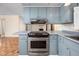 Modern kitchen with stainless steel oven and stove top beneath stylish cabinets at 926 Allister Rd, Durham, NC 27703