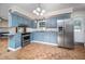 Well-lit kitchen boasting modern stainless-steel appliances, and stylish cabinetry at 926 Allister Rd, Durham, NC 27703