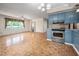 Bright living area with wood pattern flooring, stainless steel oven, and open layout to adjoining rooms at 926 Allister Rd, Durham, NC 27703