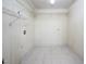 A walk-in closet featuring neutral paint, tile floor, and metal shelving for organization at 926 Allister Rd, Durham, NC 27703