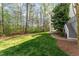 Expansive backyard featuring green grass and access to upper deck via exterior stairs at 944 Alden Bridge Dr, Cary, NC 27519