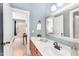 Bathroom with single sink vanity, mirror, tile backsplash and doorway leading to another room in an open layout at 944 Alden Bridge Dr, Cary, NC 27519