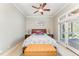 Cozy bedroom featuring a ceiling fan, bench, and glass doors leading to a sunroom at 944 Alden Bridge Dr, Cary, NC 27519