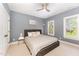 A cozy bedroom features a queen bed, neutral color palette, ceiling fan and natural light from a window at 944 Alden Bridge Dr, Cary, NC 27519