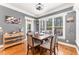 Sunlit dining room with gray walls, dark wood table, and six chairs at 944 Alden Bridge Dr, Cary, NC 27519