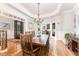 Charming dining room with wood table, chandelier, and hardwood floors at 944 Alden Bridge Dr, Cary, NC 27519