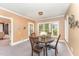 Bright dining room with a round wooden table and lush outdoor views at 944 Alden Bridge Dr, Cary, NC 27519