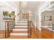 Elegant foyer with hardwood floors, staircase, and ornate moldings at 944 Alden Bridge Dr, Cary, NC 27519