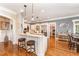 Bright kitchen with island, bar seating, granite countertops, and stainless steel appliances at 944 Alden Bridge Dr, Cary, NC 27519