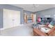 Spacious living room features an ensuite, and adjacent room with ceiling fan, brown sofa, and neutral carpet at 944 Alden Bridge Dr, Cary, NC 27519