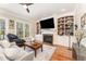 Bright living room featuring built-in shelving and fireplace at 944 Alden Bridge Dr, Cary, NC 27519