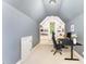Finished attic space with built in shelving used as an office, complete with desk, chair and computer at 944 Alden Bridge Dr, Cary, NC 27519