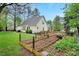 Garden bed compliments a lawn and home with wooden fence enclosing the backyard at 95 Torrington Ave, Franklinton, NC 27525