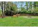 Backyard features a swing, a fire pit, a well-maintained lawn, and a wooden fence at 95 Torrington Ave, Franklinton, NC 27525