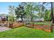 A garden bed complements a lawn enclosed by a wooden fence, enhancing the backyard's appeal at 95 Torrington Ave, Franklinton, NC 27525