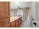 Bathroom with double vanity, wood cabinets, and well lit mirrors at 95 Torrington Ave, Franklinton, NC 27525