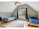 Bright bedroom with two twin beds, large window, ceiling fan, and light hardwood floors at 95 Torrington Ave, Franklinton, NC 27525