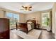 Cozy bedroom with hardwood floors, large windows, and a comfortable bed at 95 Torrington Ave, Franklinton, NC 27525