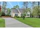 View of the charming home featuring a basketball court, long driveway, and well-maintained landscaping at 95 Torrington Ave, Franklinton, NC 27525