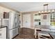Eat-in kitchen area features a stainless steel refrigerator, dining table, and laundry room access at 95 Torrington Ave, Franklinton, NC 27525