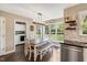 Kitchen with dining area features stainless steel appliances, bright windows, and access to the laundry room at 95 Torrington Ave, Franklinton, NC 27525