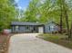 Charming single-story home featuring an attached garage and a concrete driveway at 1015 Castalia Dr, Cary, NC 27513