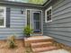 Inviting front porch and door details, including brick steps and stylish welcome mat at 1015 Castalia Dr, Cary, NC 27513