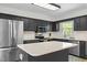 Modern kitchen with stainless steel appliances, quartz counters, and center island at 1015 Castalia Dr, Cary, NC 27513