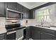 Updated kitchen showcasing sleek countertops, stainless steel appliances, and ample cabinet space at 1015 Castalia Dr, Cary, NC 27513