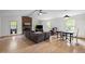 Bright living room featuring a brick fireplace, wood flooring, and comfortable seating arrangement at 1015 Castalia Dr, Cary, NC 27513
