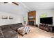 Cozy living room with a brick fireplace, wood stove insert and comfortable sectional sofa at 1015 Castalia Dr, Cary, NC 27513