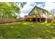 Expansive backyard with a raised deck and lush green grass, creating a private outdoor oasis at 1023 Kent St, Durham, NC 27707