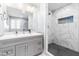 Elegant bathroom featuring a double sink vanity and a spacious walk-in shower with stylish tile at 1023 Kent St, Durham, NC 27707