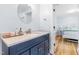 Bathroom features a sleek blue vanity with a white countertop and modern fixtures at 1023 Kent St, Durham, NC 27707