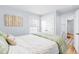 Comfortable bedroom showcasing a large bed, natural light, and access to other rooms at 1023 Kent St, Durham, NC 27707