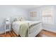 Cozy bedroom features hardwood floors, light blue walls, and a white metal frame bed at 1023 Kent St, Durham, NC 27707