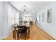 Dining room with hardwood floors, a modern chandelier, and open access to other rooms at 1023 Kent St, Durham, NC 27707