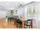 Dining room with hardwood floors, a modern chandelier, and access to the kitchen at 1023 Kent St, Durham, NC 27707