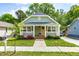 Charming home featuring a welcoming front porch, complemented by lush landscaping and a well-maintained lawn at 1023 Kent St, Durham, NC 27707