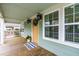Charming front porch featuring a wooden deck, decorative lights, and views of the surrounding neighborhood at 1023 Kent St, Durham, NC 27707