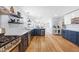 Bright open concept kitchen with two-tone cabinets, island seating, and stainless appliances at 1023 Kent St, Durham, NC 27707