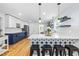 Modern kitchen with a center island, white backsplash, and stainless steel appliances at 1023 Kent St, Durham, NC 27707