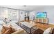 Spacious living room with hardwood floors, a sectional sofa, and access to other rooms, perfect for entertaining at 1023 Kent St, Durham, NC 27707
