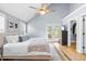 Bright bedroom boasts a ceiling fan, plush bed, walk-in closet, and access to outdoor deck at 1023 Kent St, Durham, NC 27707
