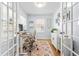 Bright home office with a white desk, ergonomic chair, and French doors at 1023 Kent St, Durham, NC 27707