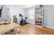 Office space showcasing a Peloton bike, shelving unit, and hardwood floors at 1023 Kent St, Durham, NC 27707