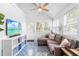 Cozy sunroom with a comfortable sectional, TV, and blue-patterned tile flooring, perfect for relaxation at 1023 Kent St, Durham, NC 27707