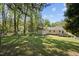 Expansive backyard featuring a shed, deck, and well-manicured lawn at 105 E Murray Ave, Durham, NC 27704