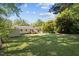 Large backyard with ample green space, featuring a deck and shed at 105 E Murray Ave, Durham, NC 27704