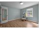 Comfortable bedroom with a window, mirror, and a padded chair with a throw pillow at 105 E Murray Ave, Durham, NC 27704